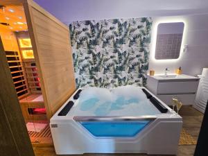 a bath tub in a bathroom with a sink at Lumina Wellness Apartman in Sátoraljaújhely