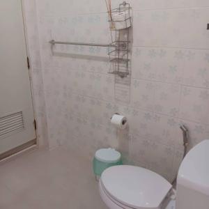 a bathroom with a toilet and a roll of toilet paper at Baan Farang in Ban Nong Chaeng