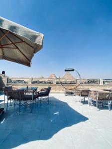 a group of chairs and tables on a patio at Golden Pyramids Night hotel in Cairo +66 photos