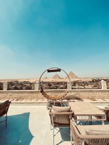 a view of the pyramids from the roof of a building at Golden Pyramids Night hotel in Cairo