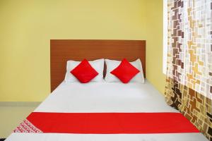 Un dormitorio con una cama con almohadas rojas y blancas. en Hotel O Sai Saugat, en Bilāspur 21 fotos más
