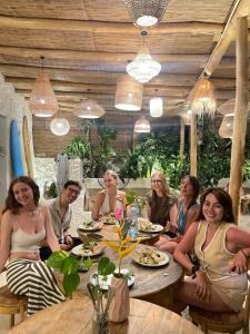 a group of people sitting at a table in a restaurant at Roaming Retreat Ahangama in Ahangama