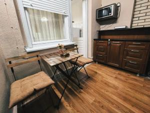 a kitchen with a table and two chairs and a tv at Nana 1 in Strumica
