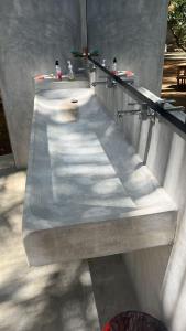a concrete counter with a sink in a wall at Ryo hostel in Ahangama