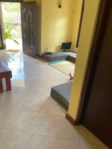 a room with a room with two beds and a door at Ryo hostel in Ahangama