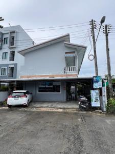 a white car parked in front of a building at J2 Airport Mansion in Thalang