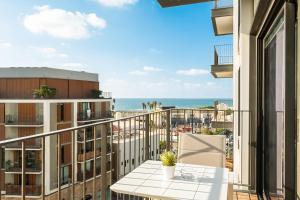 a balcony with a table and a view of the ocean at Mr Neve Tsedek in Tel Aviv