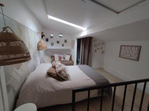a bedroom with a bed with a teddy bear on it at Le gîte d 'Amandine in Boulbon +6 photos