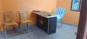 an office with two chairs and a desk with a book at DIOMAND HOTEL AND RESTURENt in Bilgrām
