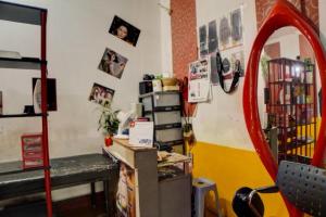 a room with a desk and a mirror at Hotel O Guesthouse 899 in Medan