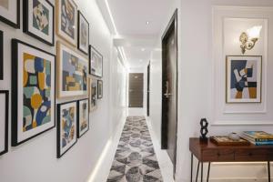 a hallway with framed art on the walls at FabHotel Peralz - Nr Boriwali Station in Mumbai