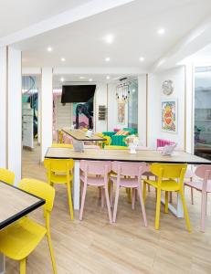 a dining room with a table and yellow chairs at Lemon & Green GuestHome in Granada +34 photos