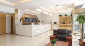 a lobby with a reception area with people standing at a counter at GreenTree Inn Langfang Xianghe County Robot Venture Port in Langfang