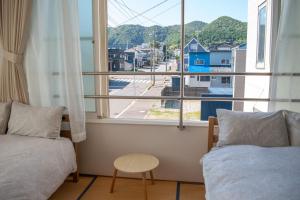 a room with two beds and a window with a view at THE HORAI New Reno 2 Toilets Next to tram station in Hakodate