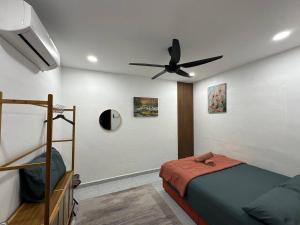 a bedroom with a bed and a ceiling fan at AliyaRoseMuslim Homestay in Ayer Keroh +23 photos