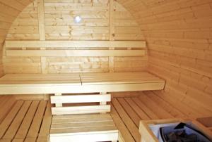 a wooden sauna with a bench in the middle at Chalet Eterlou in Tignes