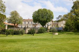 a large house with a green lawn in front of it at Domaine de Montcausson in Revel