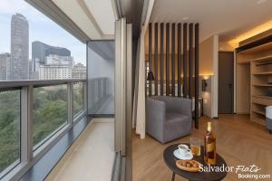 a hotel room with a view of a living room at Luxo Setin Downtown República SP in Sao Paulo +18 photos
