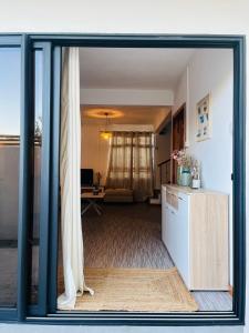 a view of a living room through a glass door at Auralis Villa in Flic-en-Flac