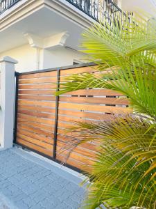 a wooden fence in front of a house at Auralis Villa in Flic-en-Flac