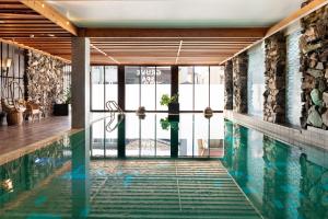 a pool in a building with a swimming pool at Quality Hotel Grand Kongsberg in Kongsberg
