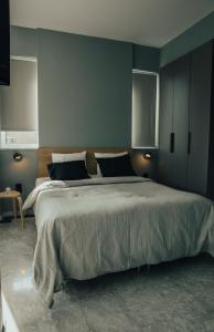 a bedroom with a large bed with blue walls at Bango Loft Chalandri, with private parking in Athens