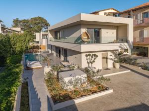 an aerial view of a house with a swimming pool at Aurea Beach Villa in Kato Daratso