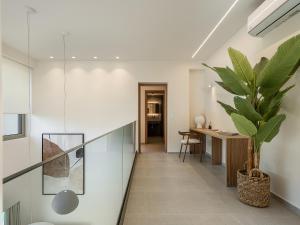 a hallway of a house with a potted plant at Aurea Beach Villa in Kato Daratso +90 photos