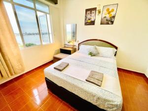 a bedroom with a bed and a large window at GloryBeachResort2BedroomWifiNetflixFreeparking in Port Dickson +31 photos