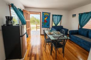 a living room with a table and a blue couch at Lily's Sunrise Villa in Ladyville