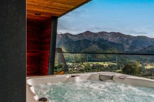 a bath tub with a view of a mountain at Landscape Villas - LoftAffair Spa Collection in Kościelisko