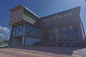 a building with a sign that reads on villas at Hotel Om Vilas in Jait