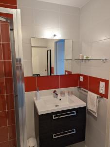 a bathroom with a sink and a mirror at Côté Phares, 4 étoiles, appartement 43 m2 Vue Mer in Les Sables-dʼOlonne