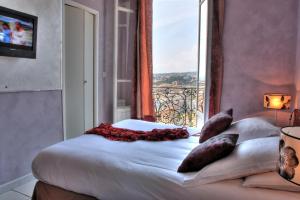 Postel nebo postele na pokoji v ubytování Le Panoramic Boutique Hôtel
