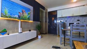 a kitchen with a large aquarium on the wall at Family Home by Havana Properties with WIFI & Free Parking near Sawa Sawa Bay Beach Restaurant in Dar es Salaam +14 photos