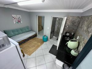 pequeña sala de estar con sofá y cocina en The Hideaway Guesthouse, en Groblersdal 10 fotos más