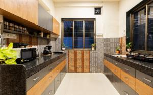 a kitchen with a counter with a microwave at Hilltop Hideaway Party Friendly 4BHK Pool Villa by Spacez in Mumbai