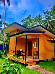 a small house with a patio and a table at Uncle peiyk homestay in Ban Bang Bao +5 photos