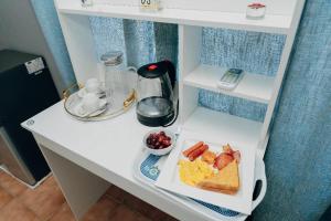 a white counter with a plate of food on it at One Apartment in Gaborone