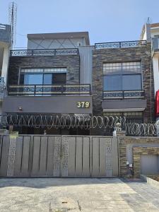a house with a gate in front of it at Noor Residence Cozy Homes G15 in Islamabad
