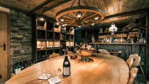 a wine bottle sitting on a wooden table in a restaurant at CHALET MOUTON a 4-Bedroom Alpine Chic Escape in Saas-Fee in Saas-Fee