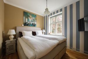 a bedroom with a large bed and a window at Köpmans Boutique Hotel & Bistro in Höganäs +81 photos