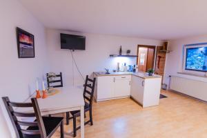 a kitchen and dining room with a table and a table and chairs at Skier‘s Lodge - Best View in Town! in Sankt Egidi +12 photos