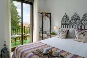 a bedroom with a bed with a view of a balcony at Mirador del Zenete in Granada +100 photos