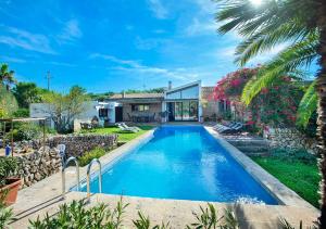 ein Swimmingpool in einem Hof mit einem Haus in der Unterkunft La Casa en el Pinar by Vintage Travel in Biniancolla