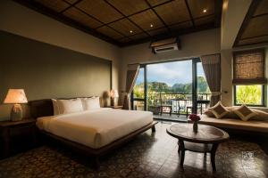 a bedroom with a bed and a large window at Le Clos Du Fil in Ninh Binh +47 photos