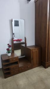 a room with a mirror and a dresser and a dresser with a dress at Sapphire Homestay in Dehiwala