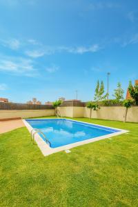 a large swimming pool in the middle of a yard at Apartamento Sol Terraza in Montgat