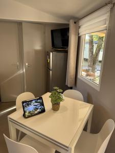 a white table with a laptop on top of it at Mobil Home 6 pers Capbreton in Capbreton