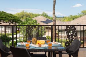 a table on a balcony with fruit on it at PiH: Kamilo Luana~ Relax rejuvenate unwind Bikes Beach Gear in Waikoloa